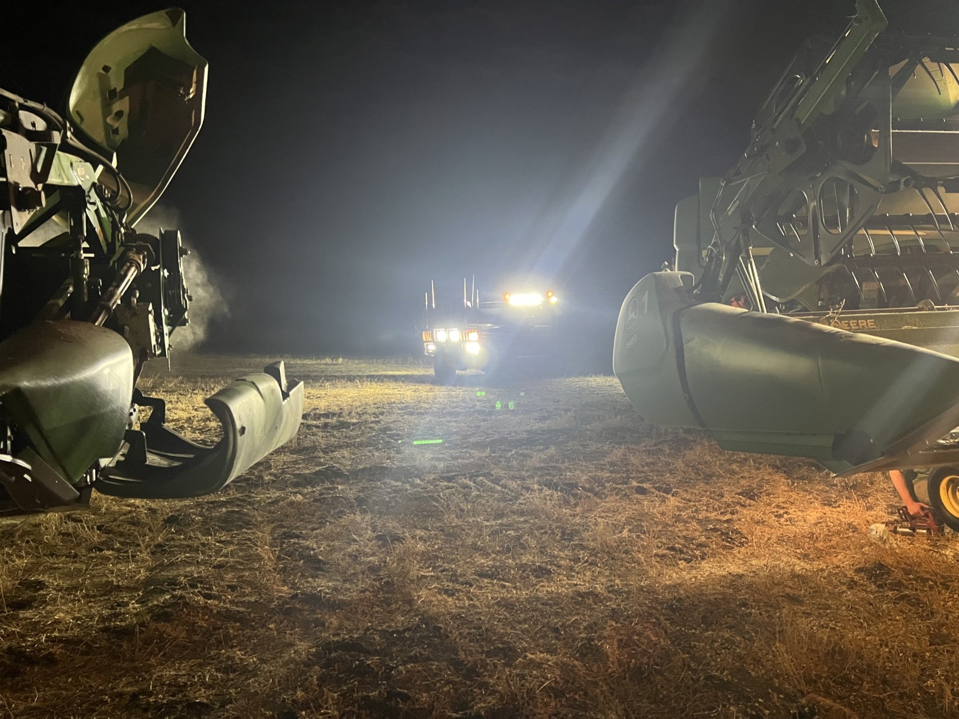 Night service on a harvester lit up in the field